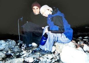Two UCSF students sitting on river rocks in the evening about 2004